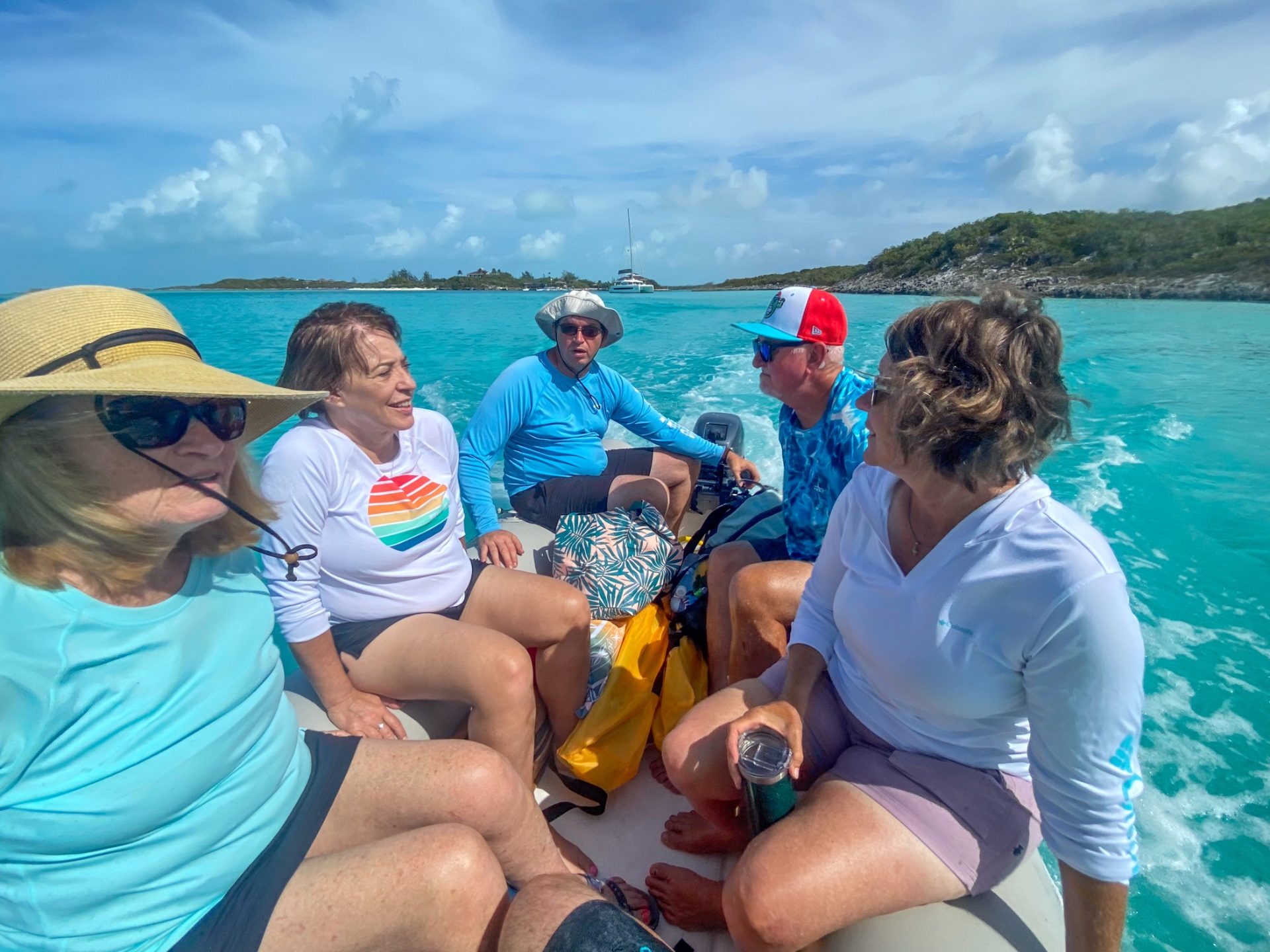 Guests cruising back to the catamaran in the dinghy